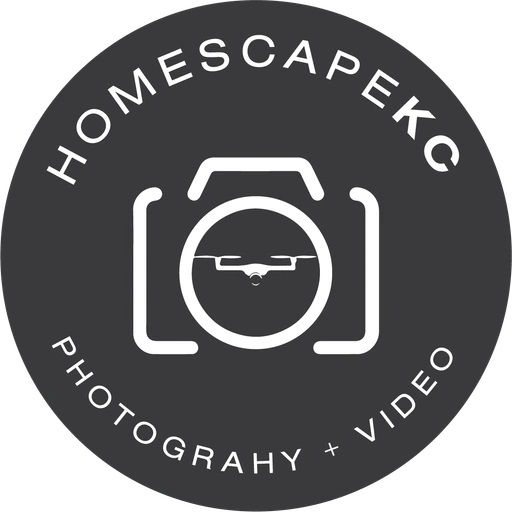 HomescapeKC camera badge, white on charcoal