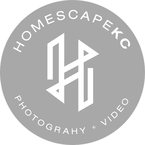 HomescapeKC H monogram badge, white on stone